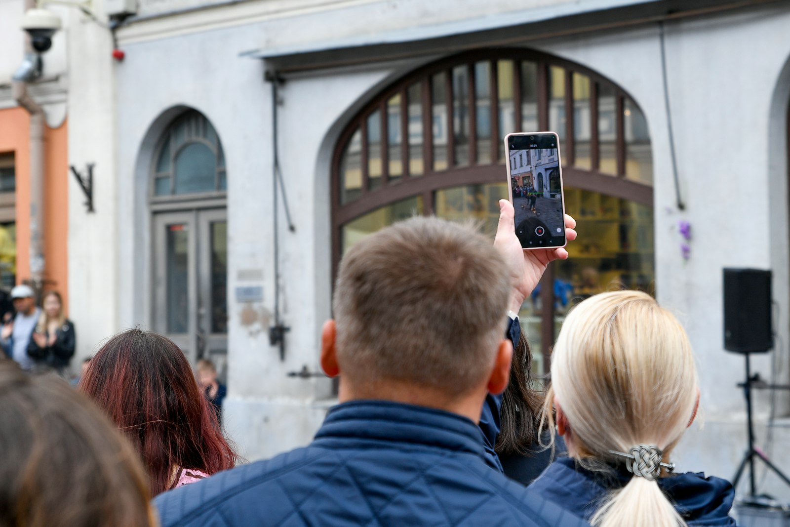 Turista fotografando com smartphone durante passeio turístico, representando o uso de apps por viajantes 60+